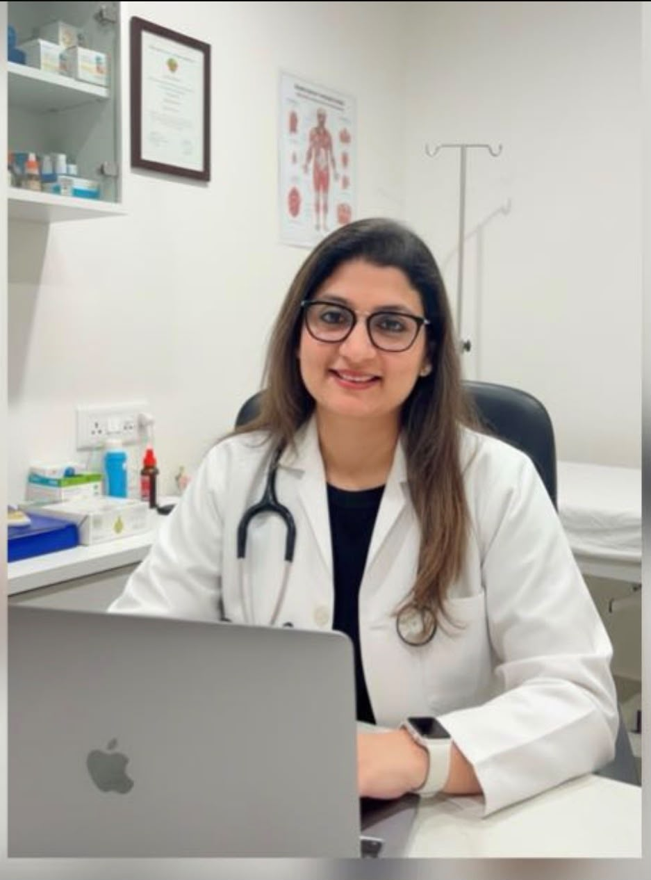 Dr. Pooja Tiwari, homeopathic physician, at her consultation desk